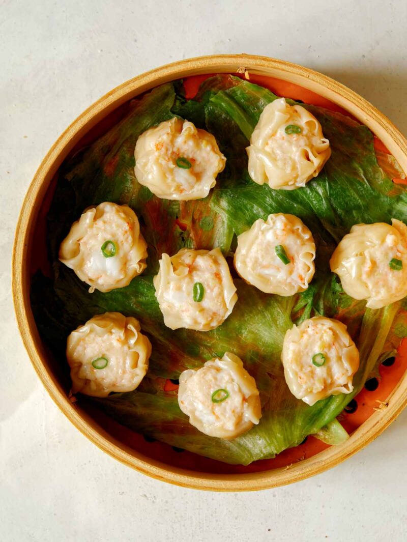 overhead of 9 Freshly steamed shrimp shumai in steamer basket