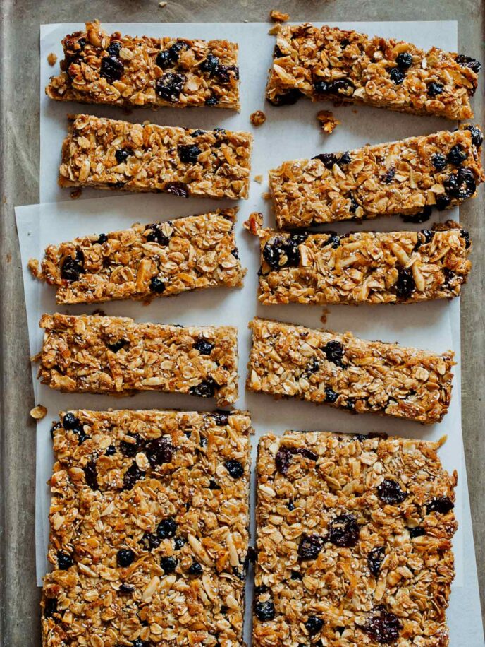 A tray of homemade granola bars with coconut and dried cherries and blueberries, a breakfast recipe. 