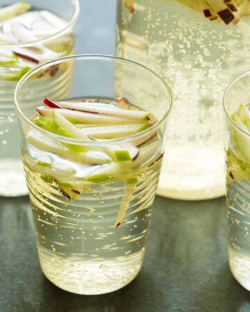 A close up of glasses of sparkling apple sangria.