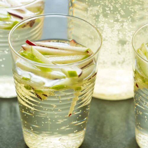 A close up of glasses of sparkling apple sangria.