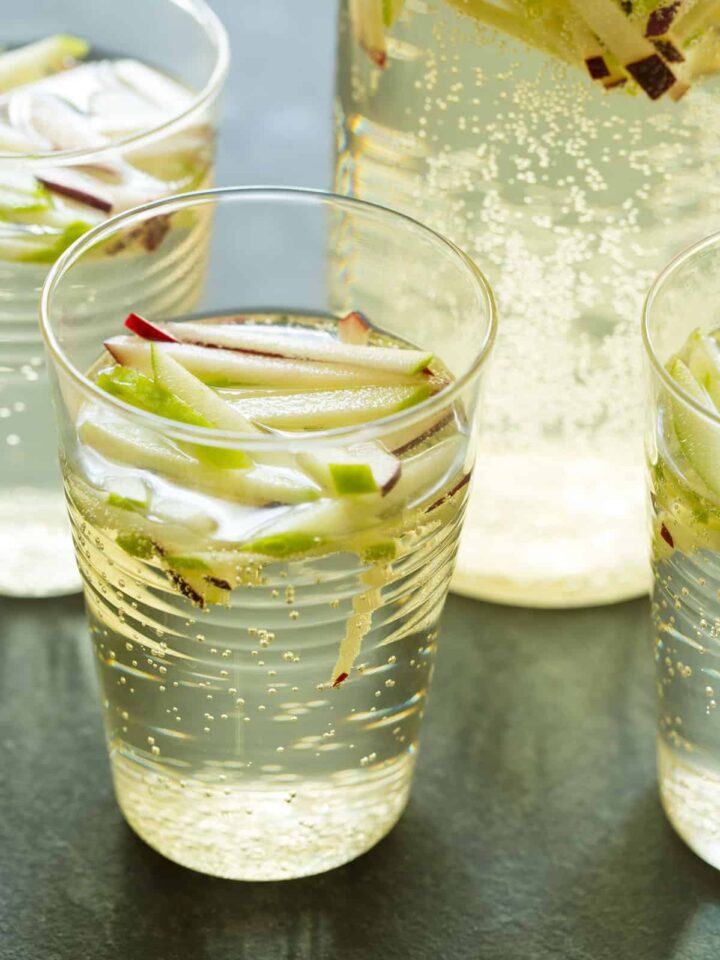 A close up of glasses of sparkling apple sangria.