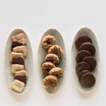 Three oval platters of a variety of homemade girl scout cookies.