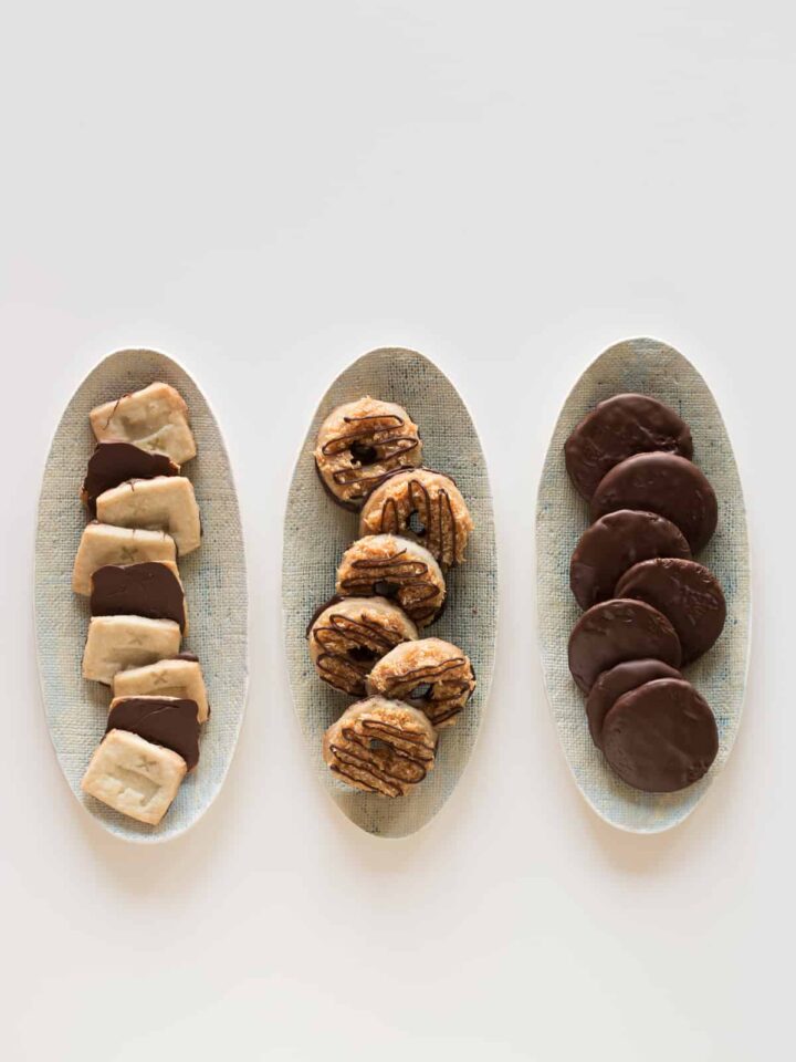 Three oval platters of a variety of homemade girl scout cookies.