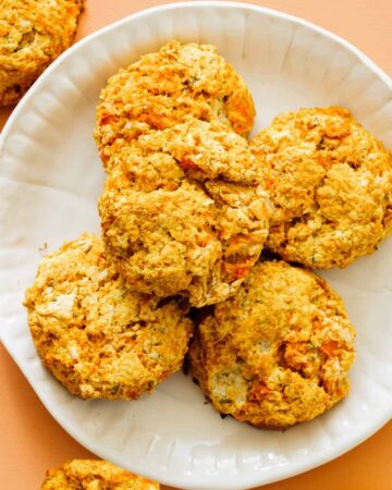 A close up of a plate of sweet potato and rosemary biscuits.