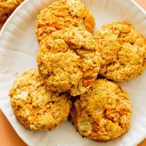 A close up of a plate of sweet potato and rosemary biscuits.