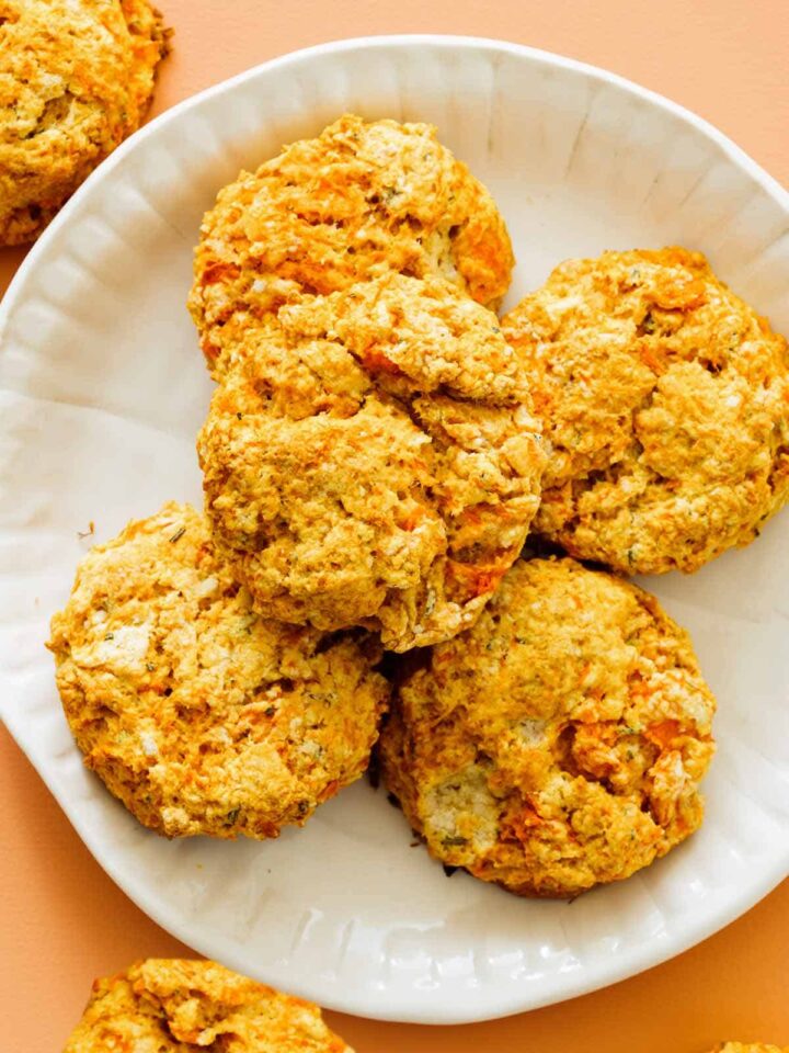 A close up of a plate of sweet potato and rosemary biscuits.