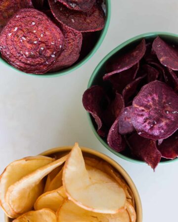 A close up of bowls of different types of root chips.