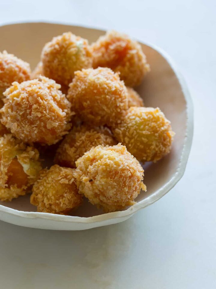 A close up of a bowl of peppadew poppers.