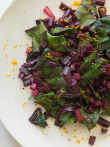 A close up of citrus sautéed beet stems.