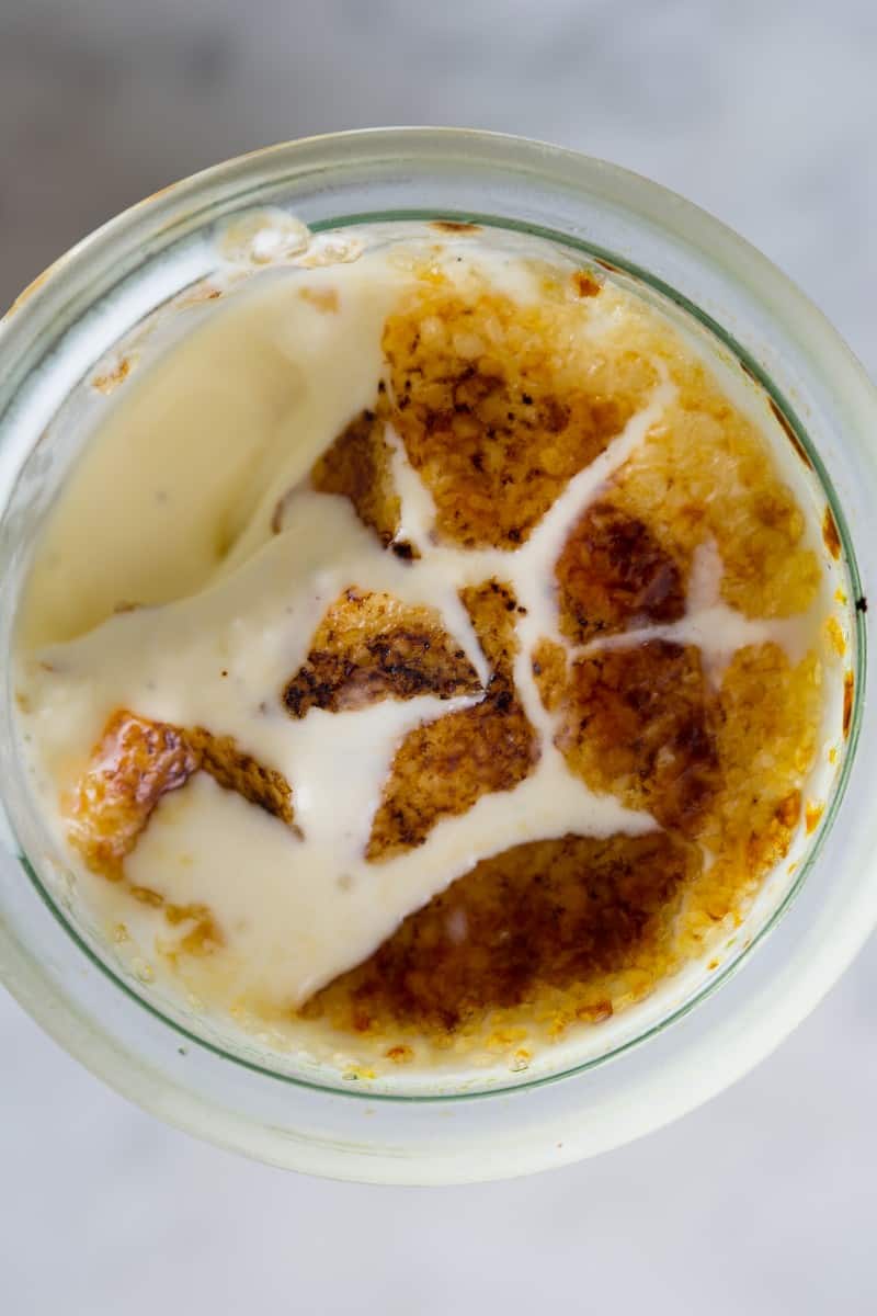 A close up of creme brûlée ice cream with the top broken open.