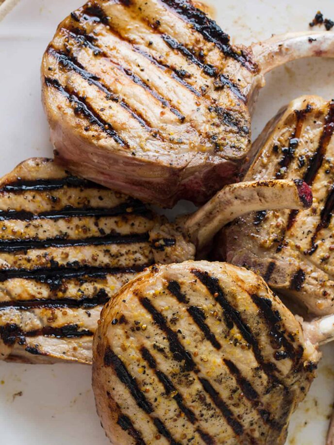 A close up of mustard crusted pork chops.