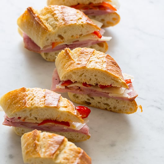 Bocadillo bites spread out on a marble kitchen counter. 