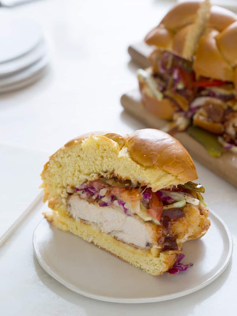 A slice of fried chicken sandwich on a small plate.