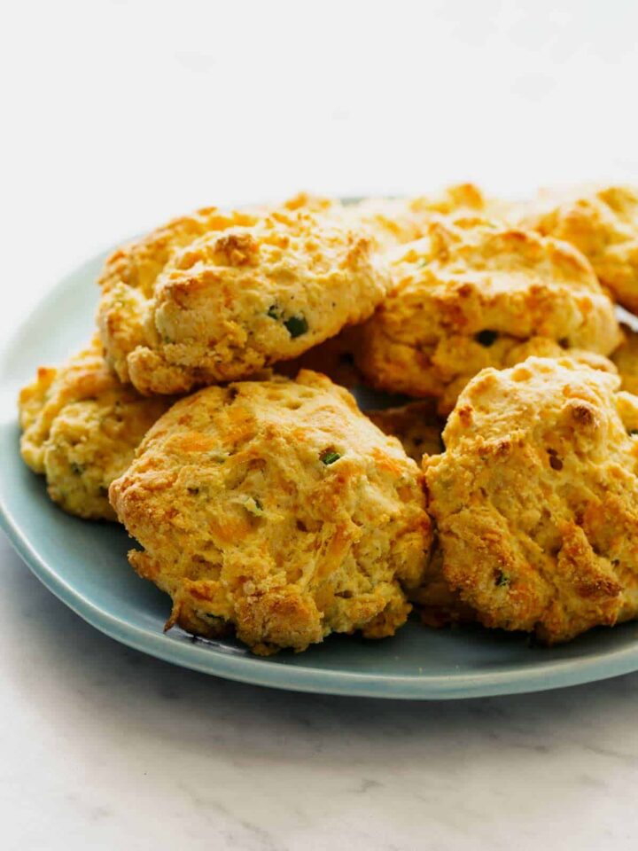 A close up of a plate of cornmeal and jalapeño cheddar biscuits.