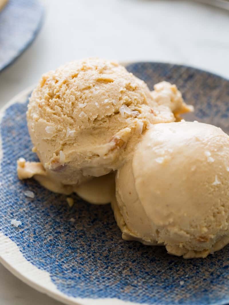Two scoops of salty nuts ice cream on a plate.