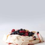 A basic pavlova with macerated berries.