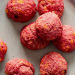 A close up of several beet and cheese biscuits.