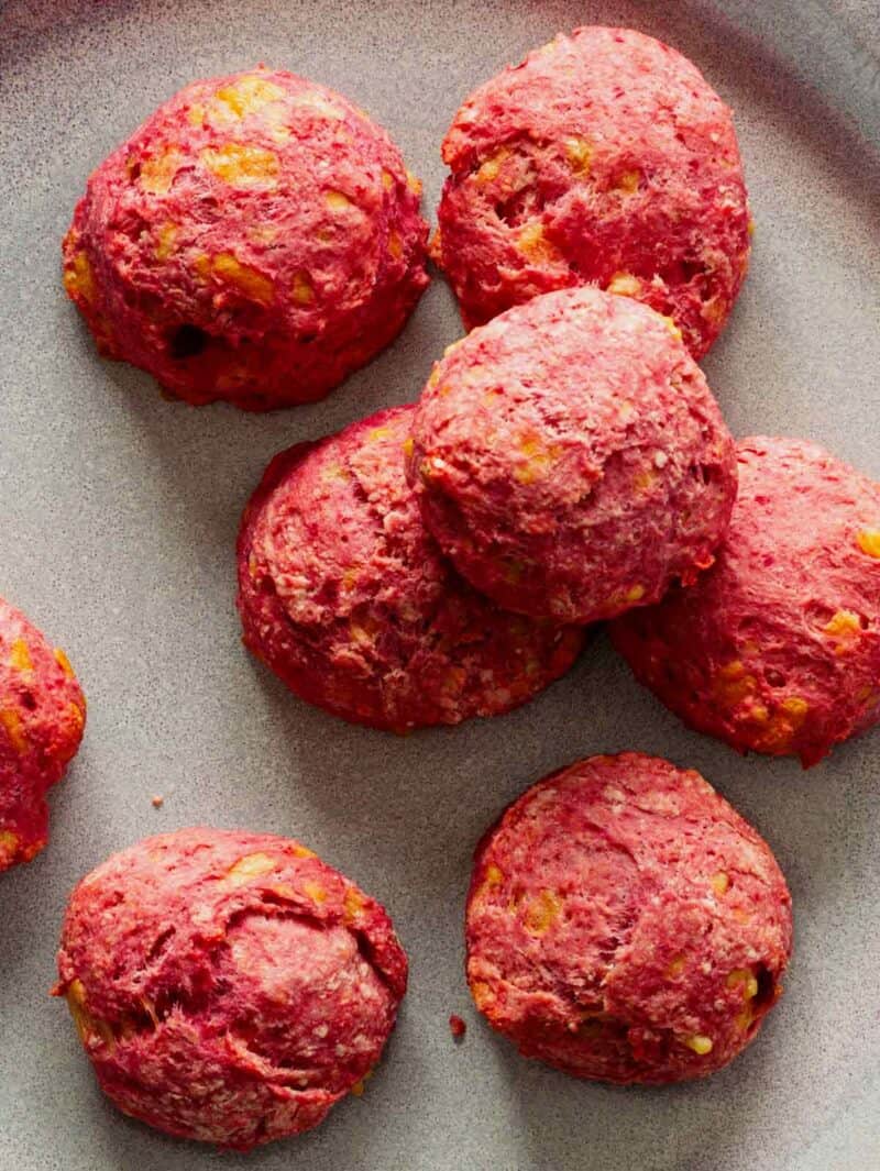 A close up of cheesy beet biscuits.