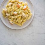 Lobster and corn pasta with white wine and tarragon cream sauce on a plate.