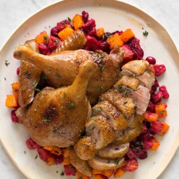 A plate of maple balsamic roasted duck with spiced cranberry persimmon chutney.