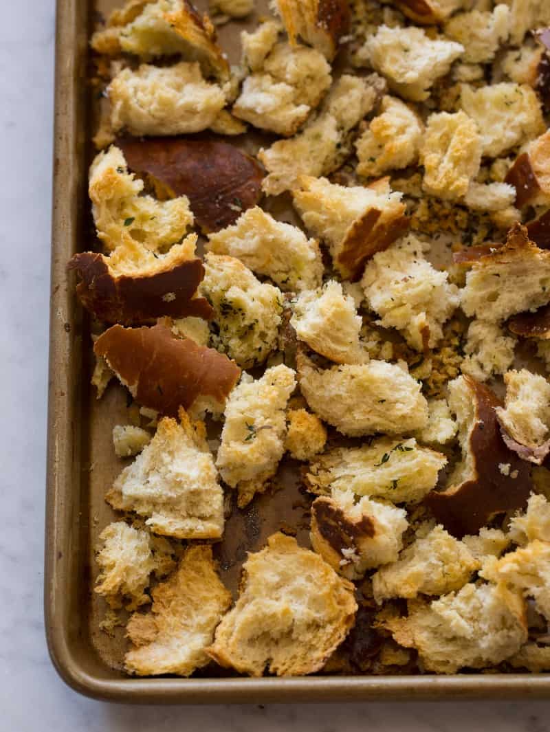 A close up of pretzel bread croutons on a sheet pan.