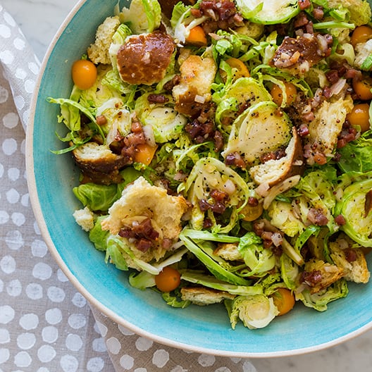 Shaved brussels sprouts salad in a blue bowl.