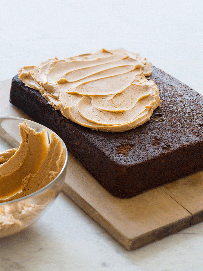 Frosting a chocolate stout cake with peanut buttercream frosting.