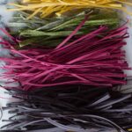 A colorful variety of homemade pastas lined up.