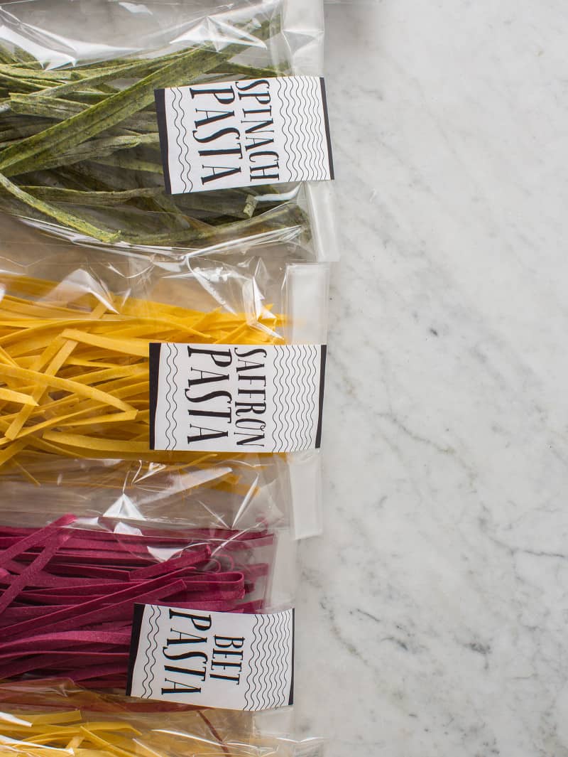 Multicolored pasta gifts with labels.