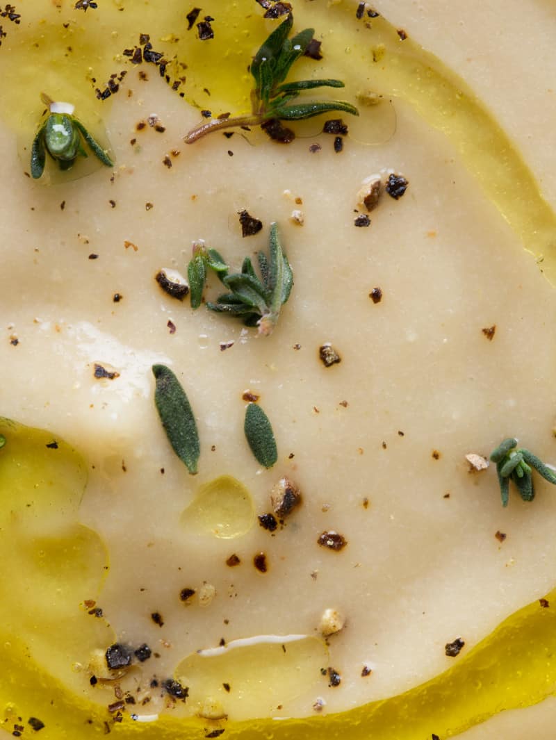 Parsnip soup topped with olive oil and thyme.