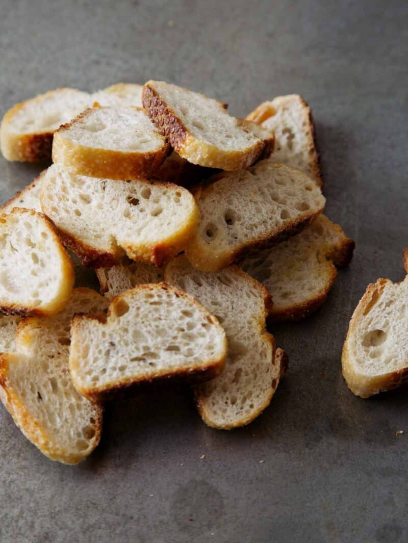 A close up of a pile of crostini.