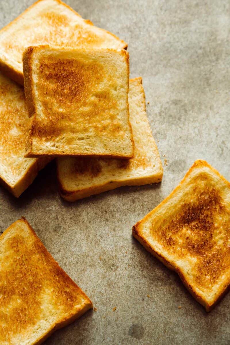 Several pieces of toasted white bread.