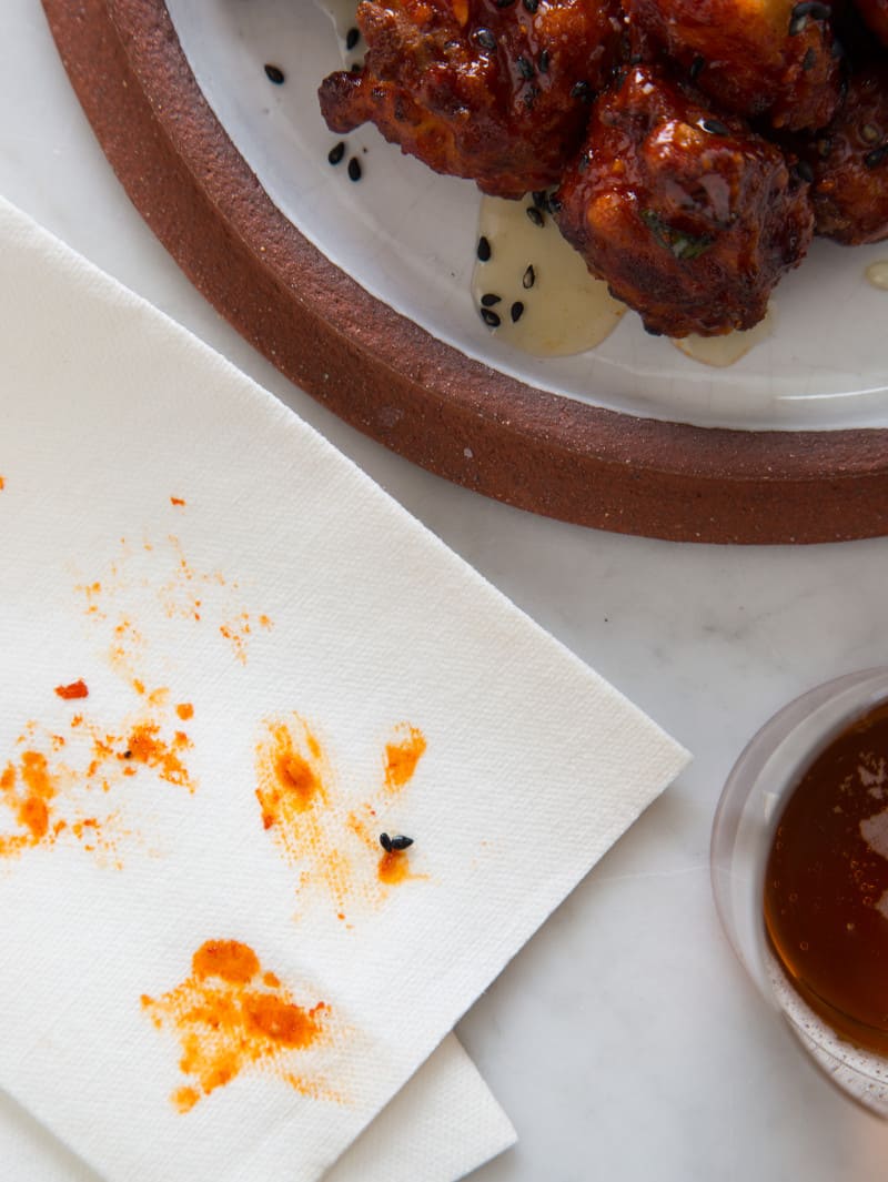 Korean Chicken Nuggets with sauce on a napkin.