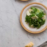 Watercress salad with green apple vinaigrette on a plate.