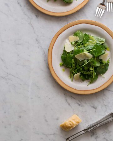 Watercress salad with green apple vinaigrette on a plate.