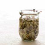 A jar of pickled mushrooms.