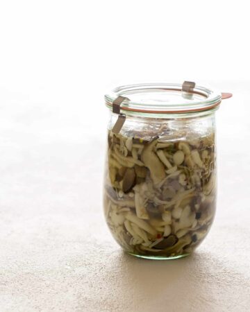 A jar of pickled mushrooms.