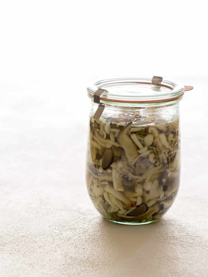 A jar of pickled mushrooms.