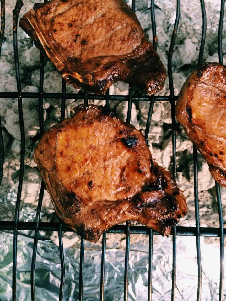 A close up of pork on a grill.