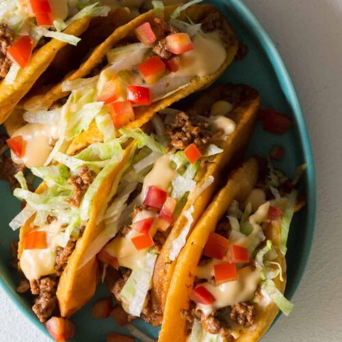 https://www.spoonforkbacon.com/wp-content/uploads/2014/11/beef_tacos_Cheesey_sauce-e1602467347532-500x500.jpg