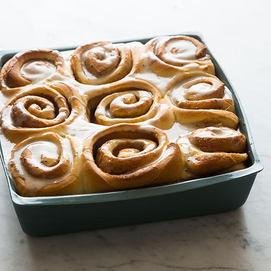 Square pan of baked cinnamon rolls.