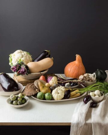 A flowerless Thanksgiving centerpiece made with a variety of fruits and vegetables.