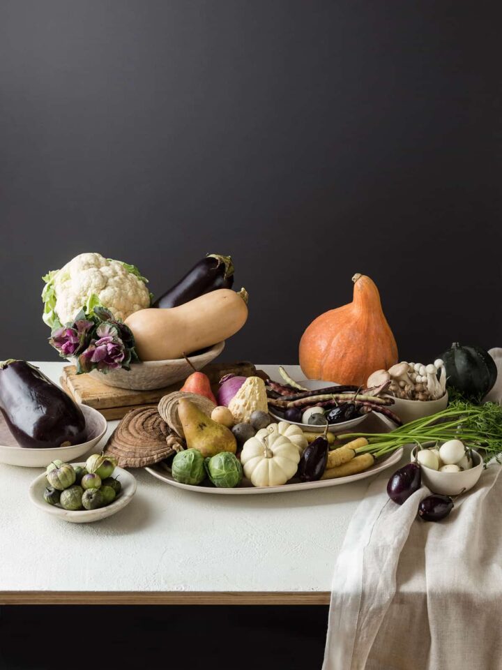 A flowerless Thanksgiving centerpiece made with a variety of fruits and vegetables.