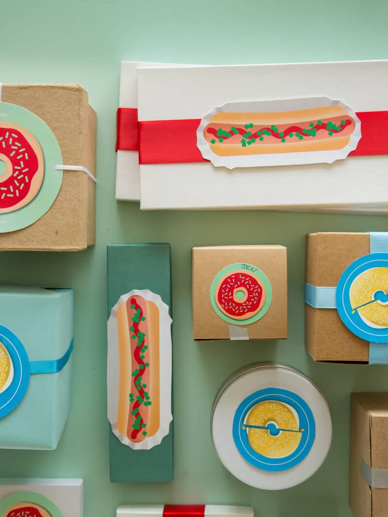 A variety of printable food gift tags on gift boxes.