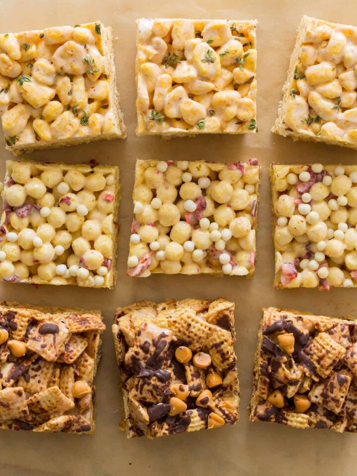 Three different kinds of marshmallow cereal treats on a piece of parchment.