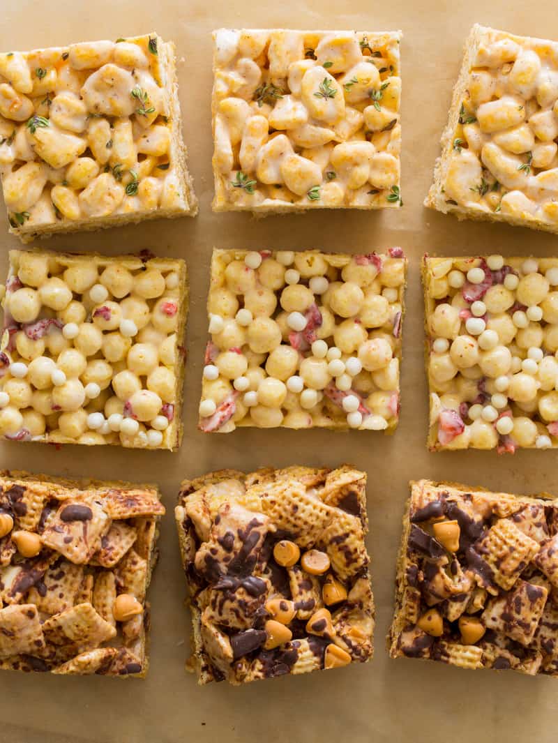 Three different kinds of marshmallow cereal treats on a piece of parchment. 