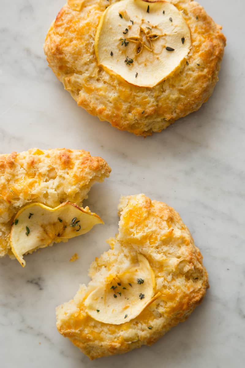 Apple cheddar scones, one broken in half.