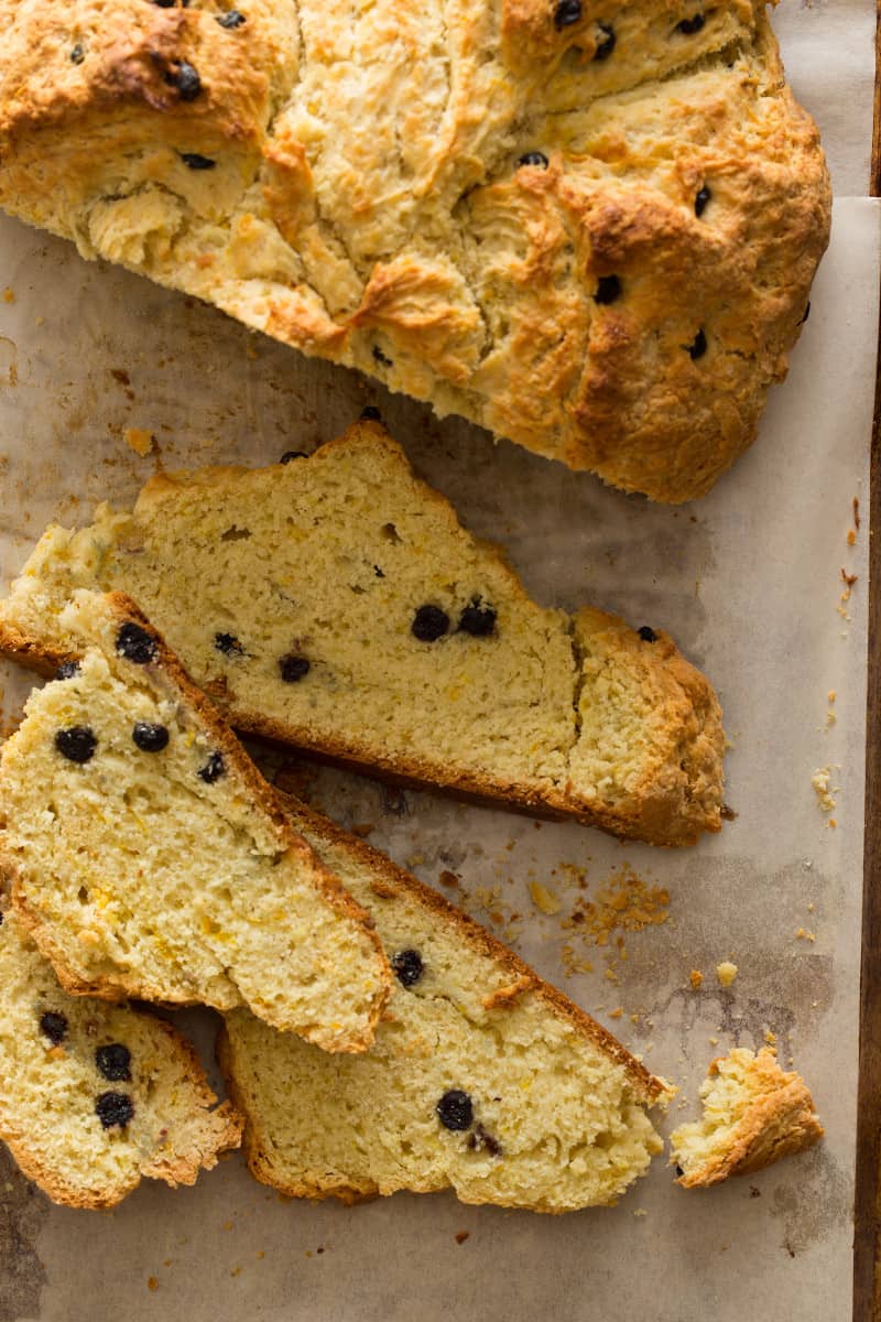 A close up of slices of Irish soda bread with dried blueberries.