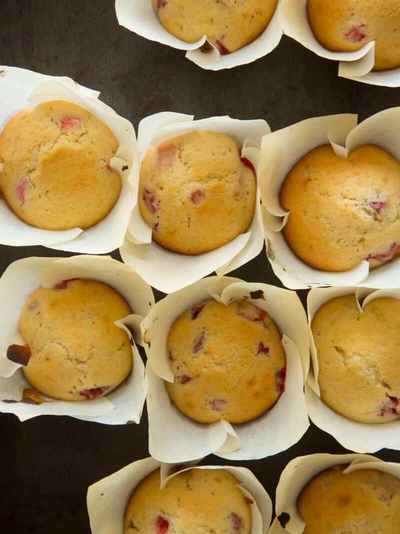 Brown Sugar Strawberry Rhubarb muffins on a baking sheet shot from overhead. 