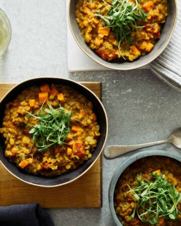 Several bowls of masoor dal. with spoons.